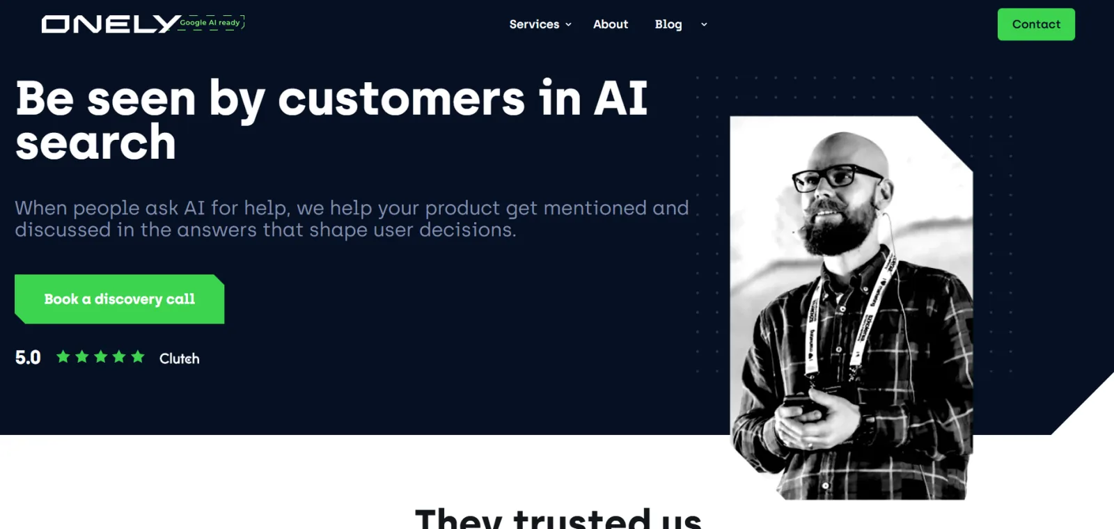Onely homepage headlined Be seen by customers in AI search, with a 5.0 Clutch rating and a black-and-white photo of a speaker
